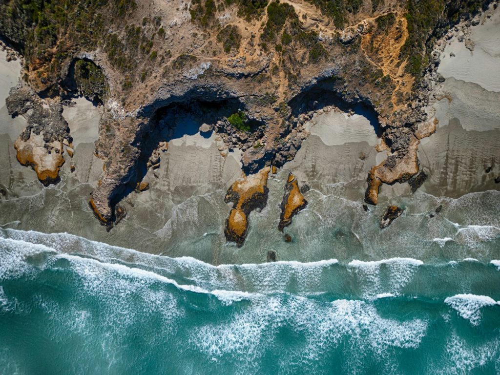 Aerial view of a rocky beach and ocean.